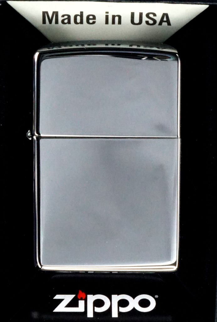 A Zippo lighter is displayed in its packaging against a black background.