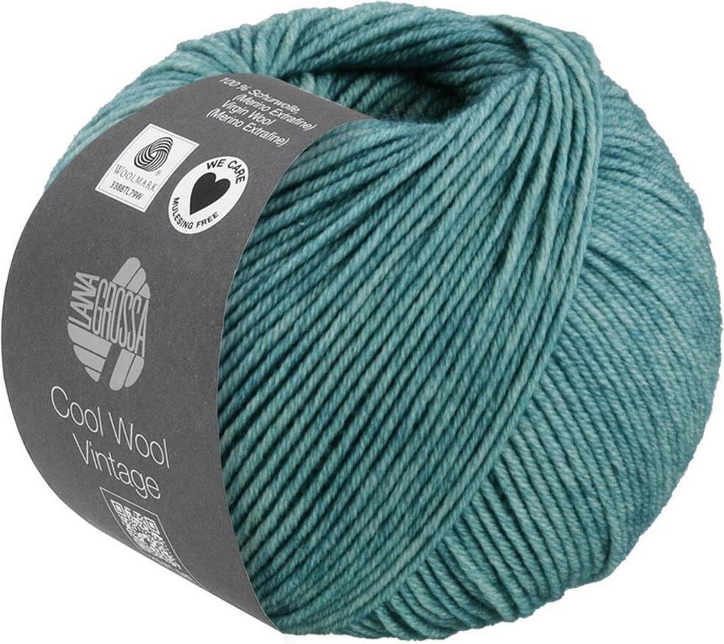 A ball of teal yarn with a label wrapped around it.