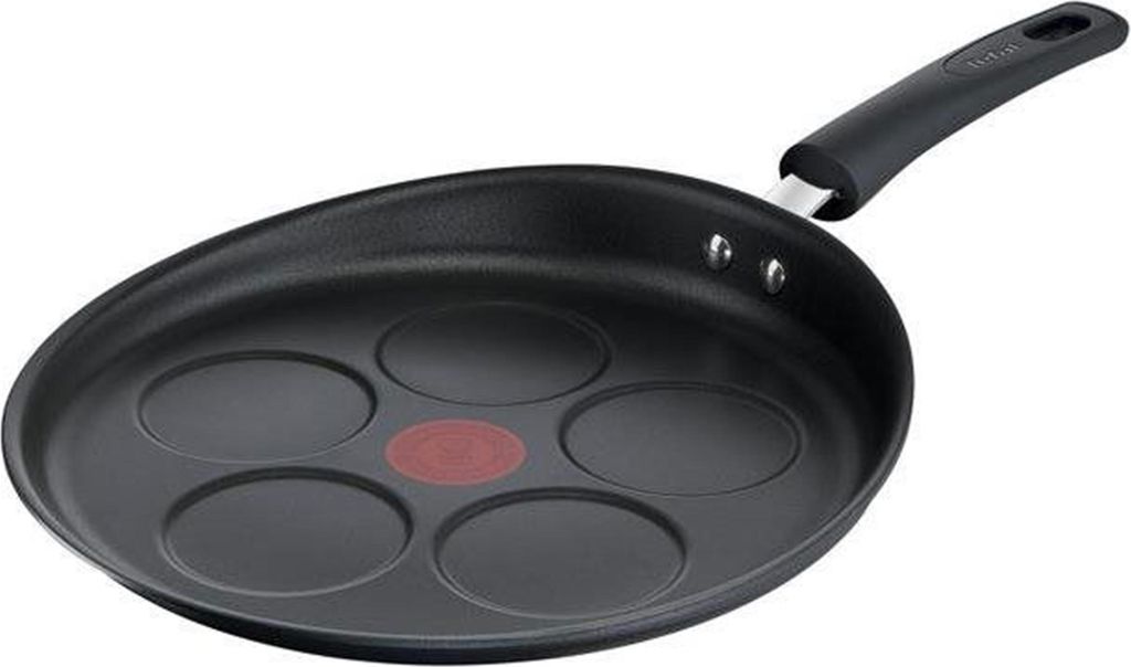 A black pancake pan with five circular indentations and a red heat indicator in the center, set against a white background.