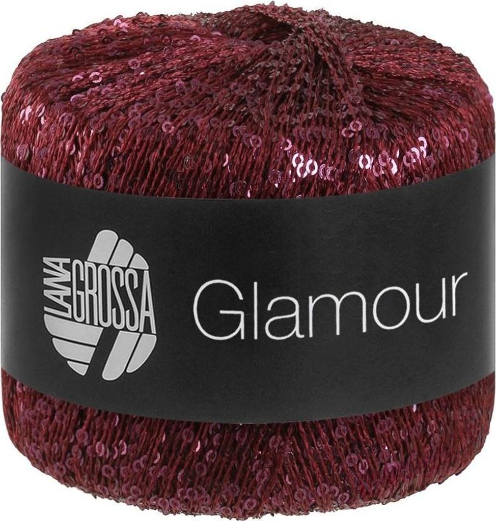 A ball of yarn with sequins, on a black label.