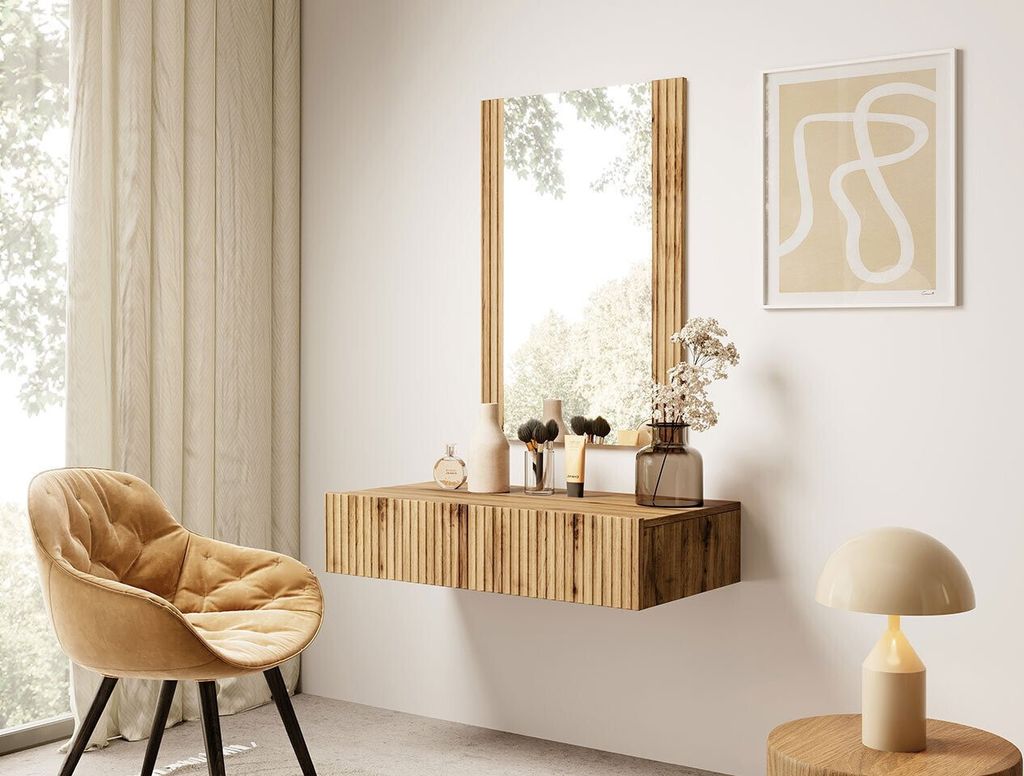A modern vanity table with a mirror and chair in a bright room.