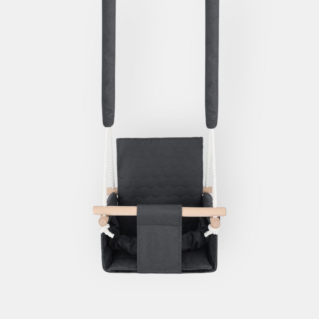 A baby swing is shown hanging from two dark gray padded straps against a white background.