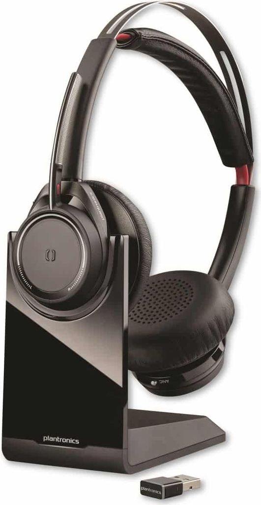 A wireless headset and its charging dock are shown against a white background.