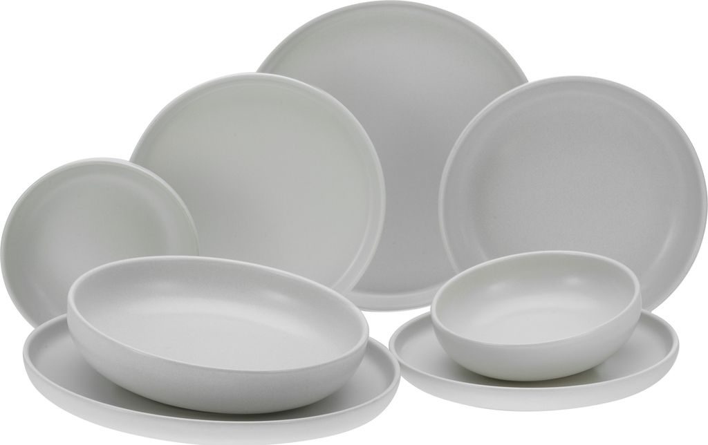 A collection of white ceramic plates and bowls arranged on a white background.