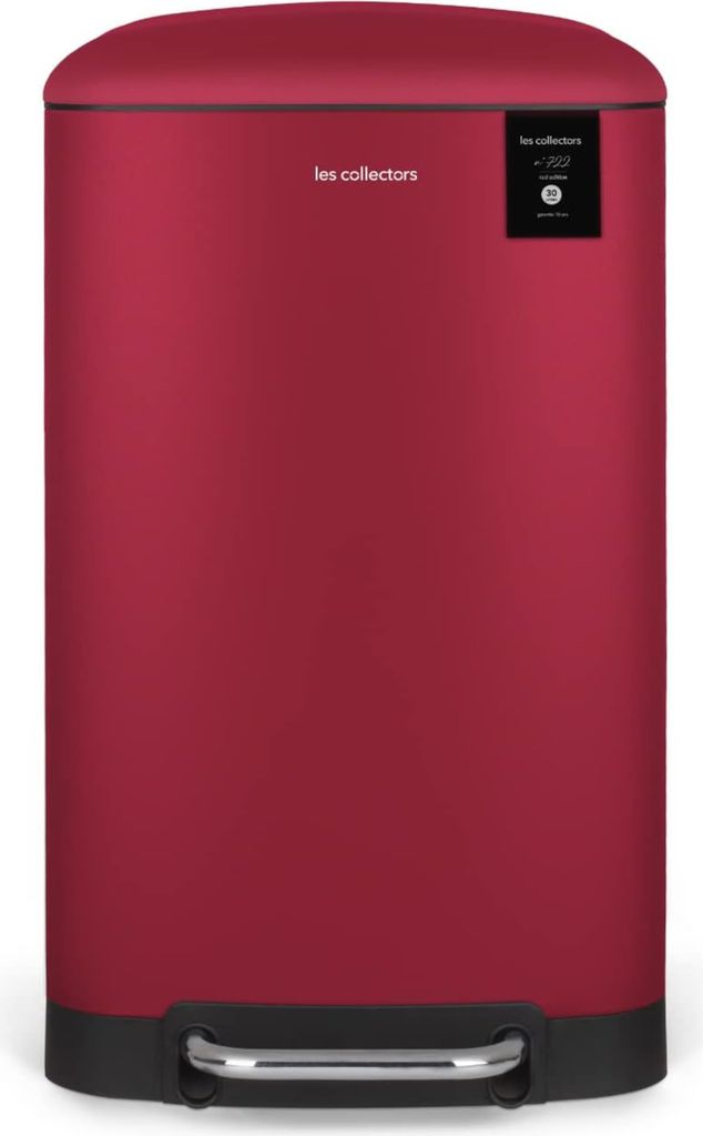 A red pedal trash can with a black base and a small black label on the top right.