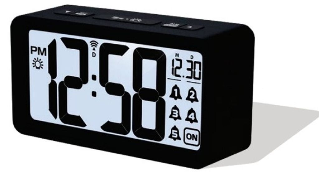 A digital alarm clock is shown against a white background.