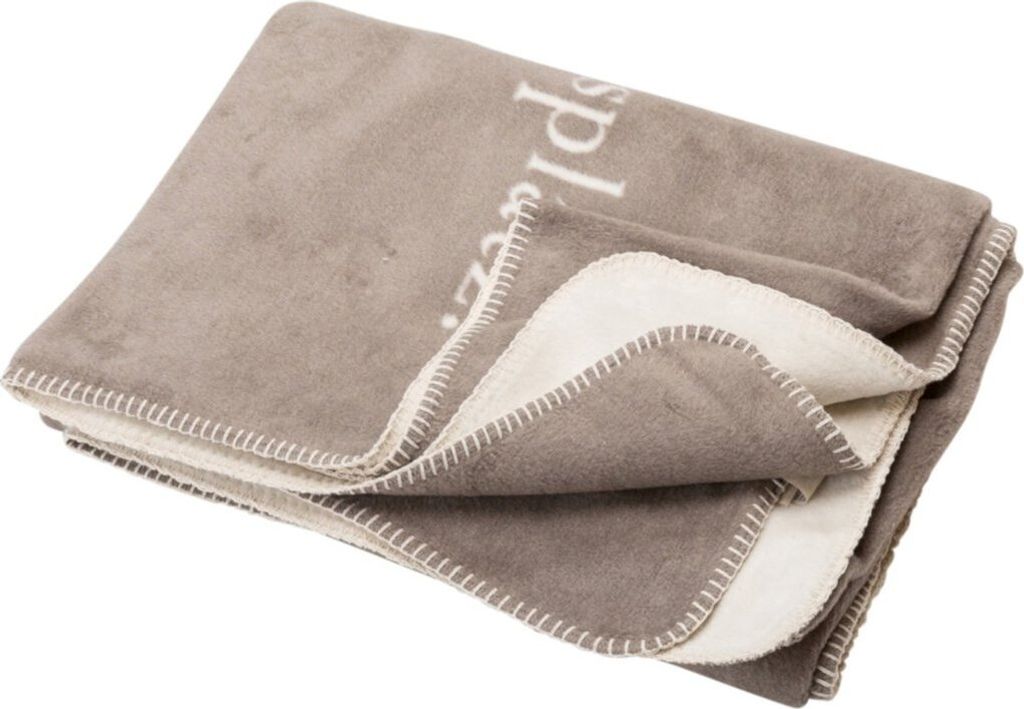 A folded blanket with a fluffy lining.