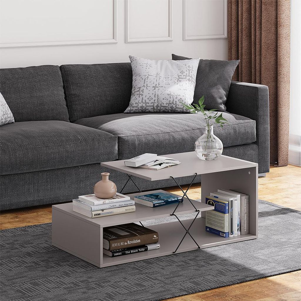 A coffee table in a living room setting with a sofa and rug.