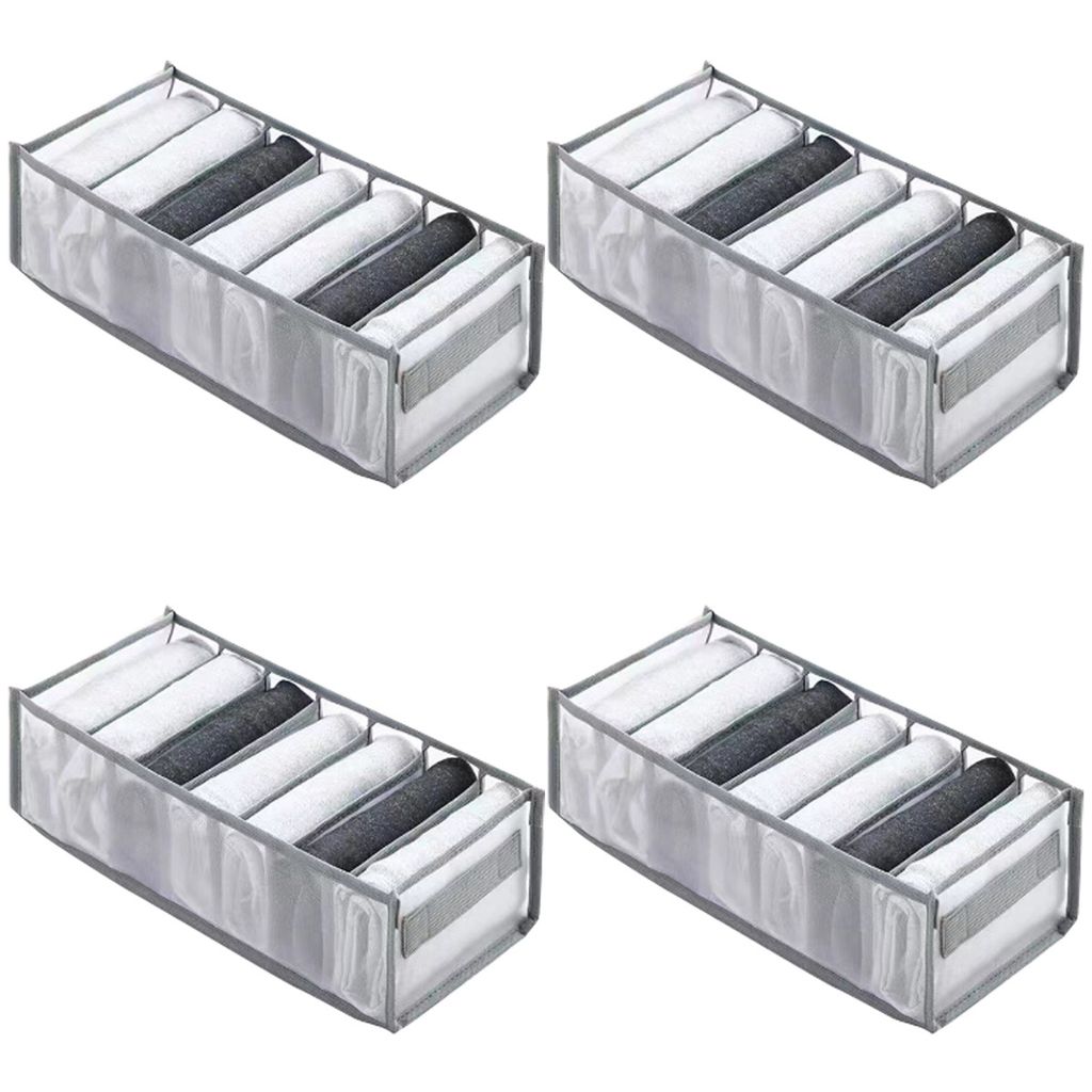 Four identical organizers filled with folded clothes.