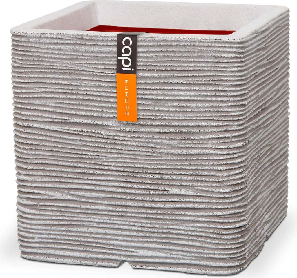 A square planter with a textured exterior and a red interior, featuring a brand tag.