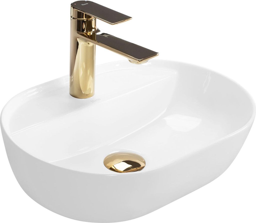 A white oval basin sink with a gold faucet and drain.