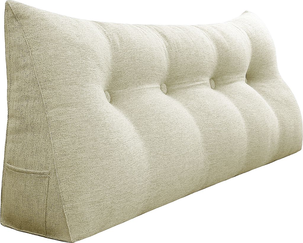 A wedge-shaped pillow with button tufting.