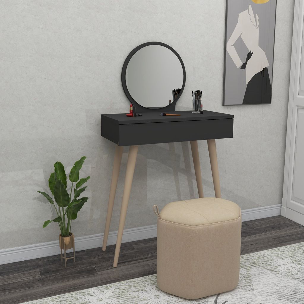 A vanity table with a mirror and stool in a room.