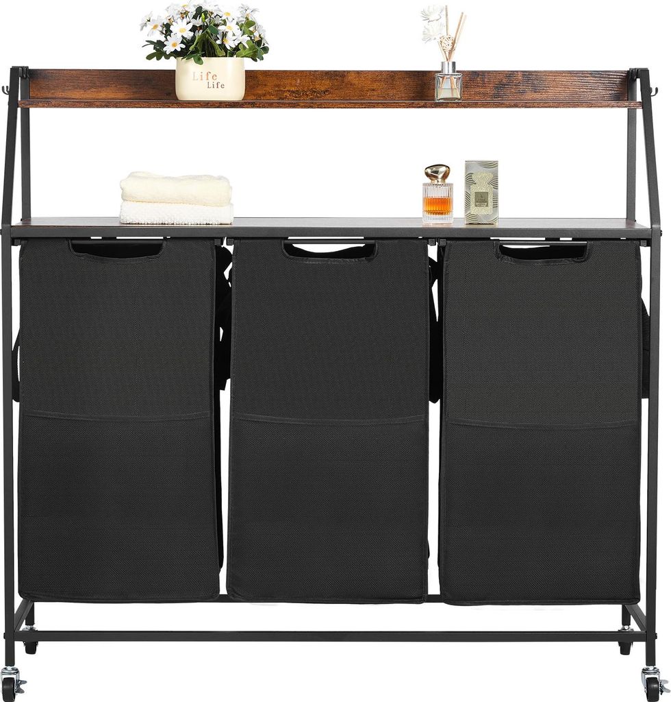 A laundry sorter with three compartments and a wooden top shelf, displayed in a studio setting.