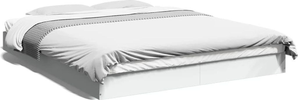 A white bed frame with white bedding and a gray and white patterned throw blanket.