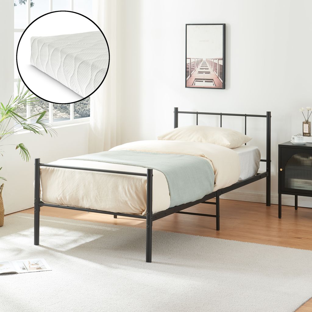 A bedroom scene with a single bed and mattress.