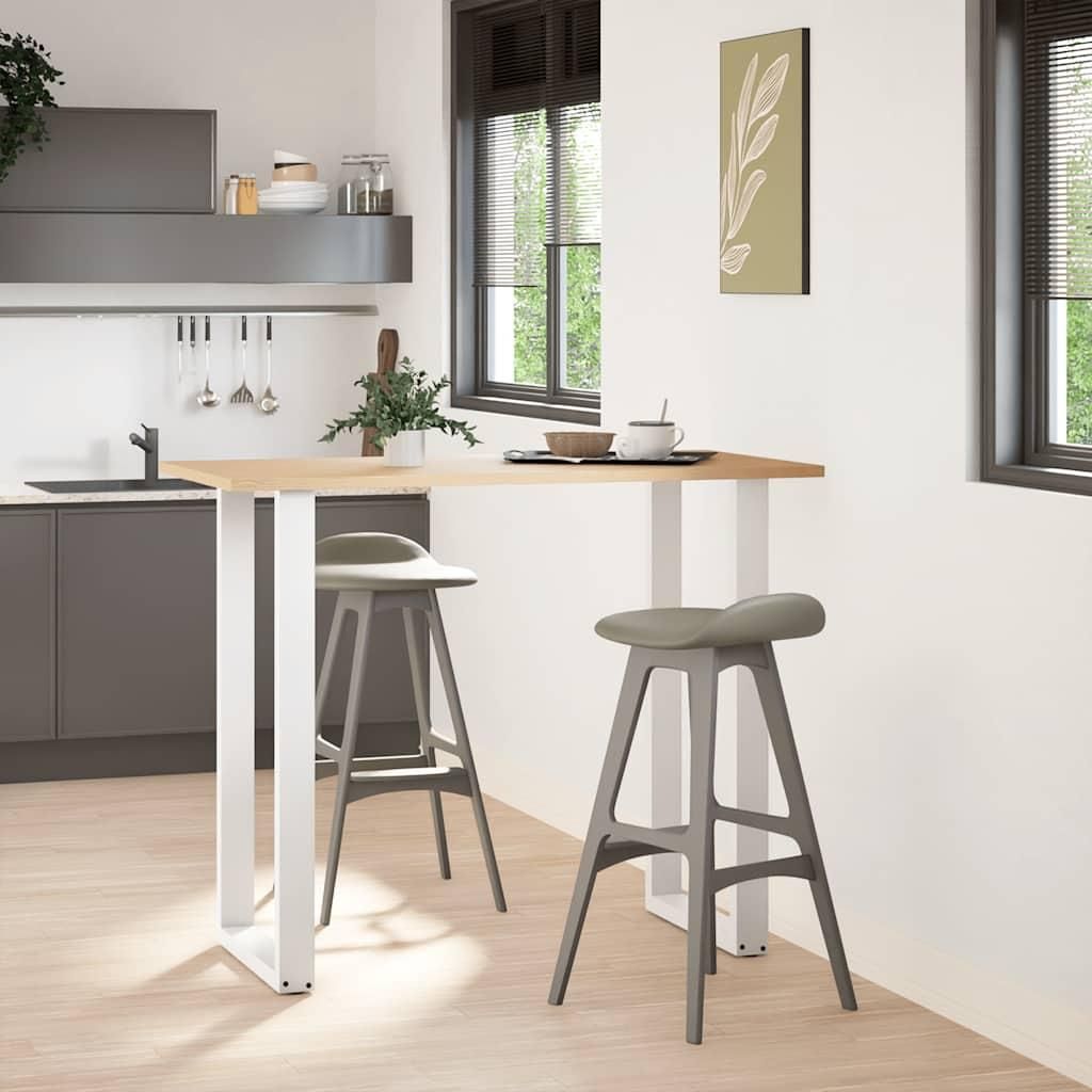 A modern kitchen with a breakfast bar and stools.