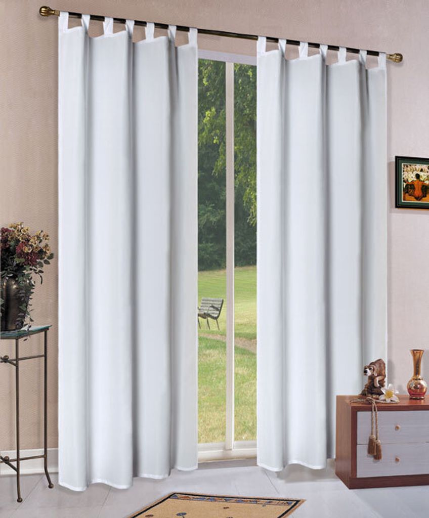 White curtains hanging in front of a window with a view of a garden.