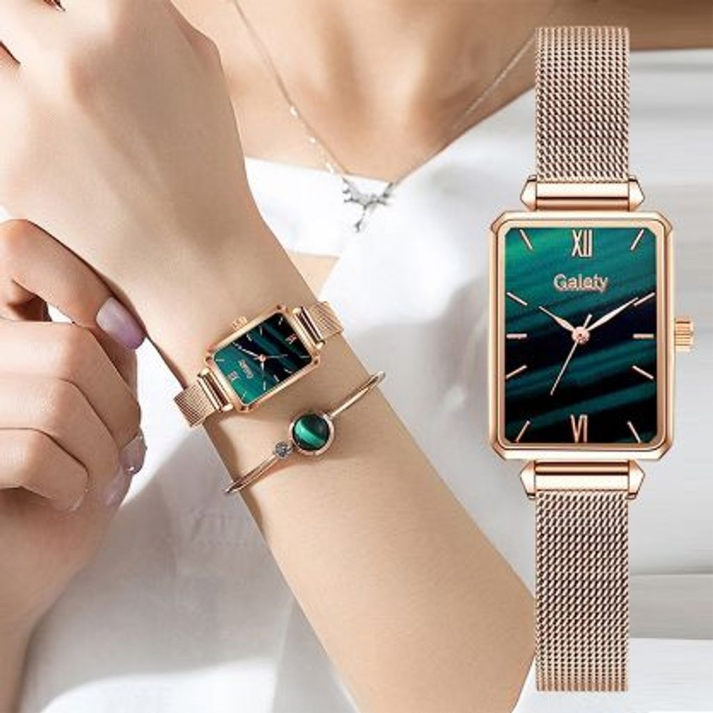 A woman's wrist wearing a gold-toned watch with a green dial and a matching bracelet.