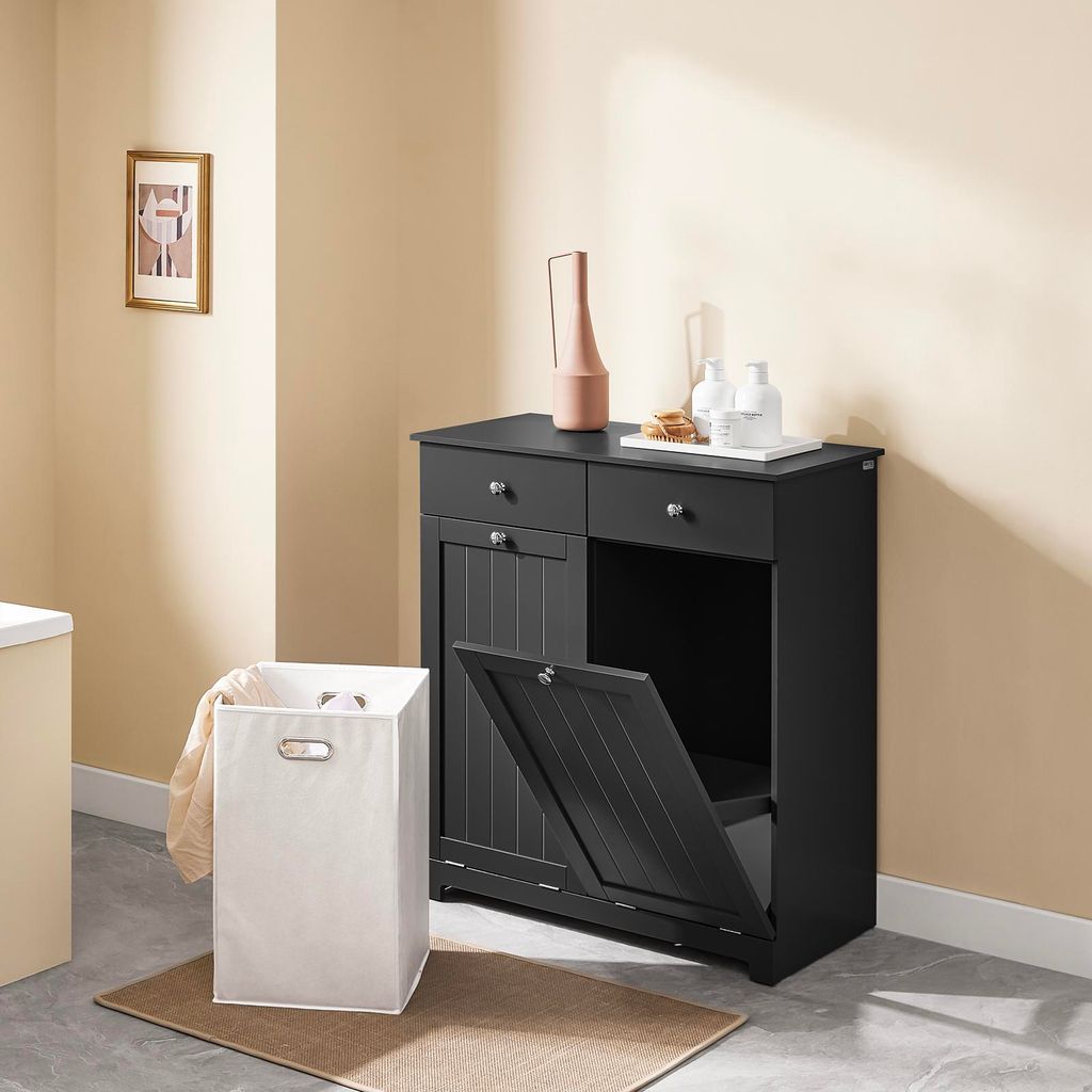 A black bathroom cabinet with a laundry basket in front of it.
