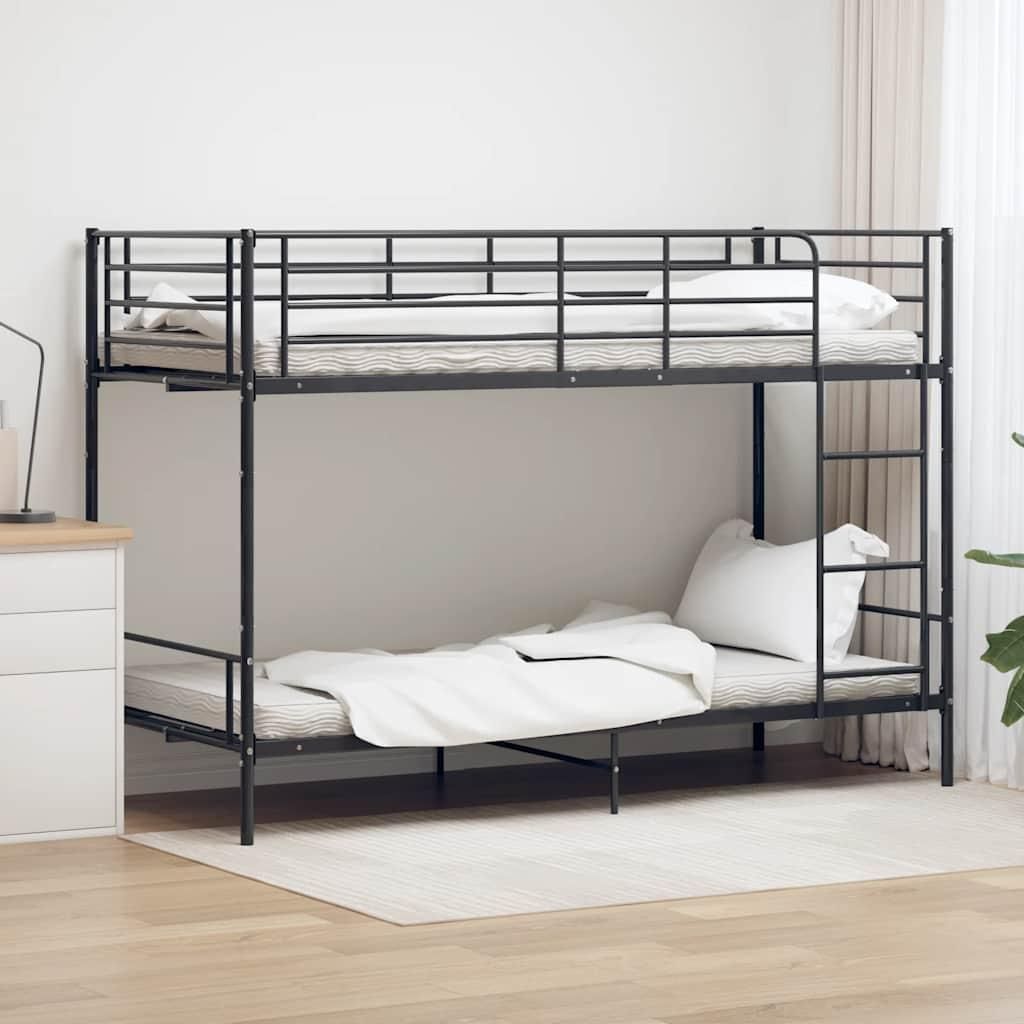 A black metal bunk bed with mattresses and white bedding in a room with light wood floors and a white rug.