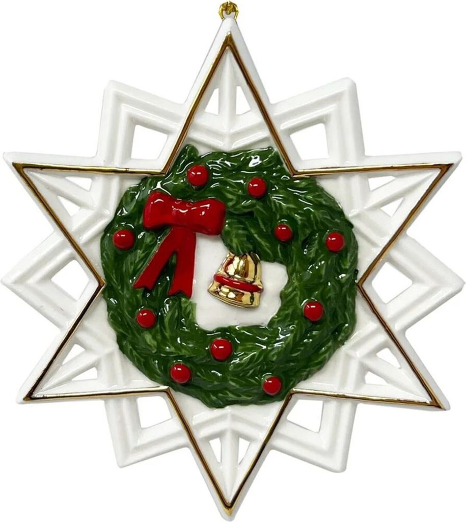 A Christmas ornament shaped like a star with a wreath in the center.
