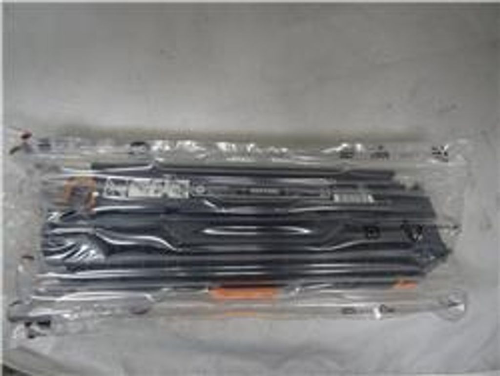 A toner cartridge is sealed in a clear plastic bag with air cushions.