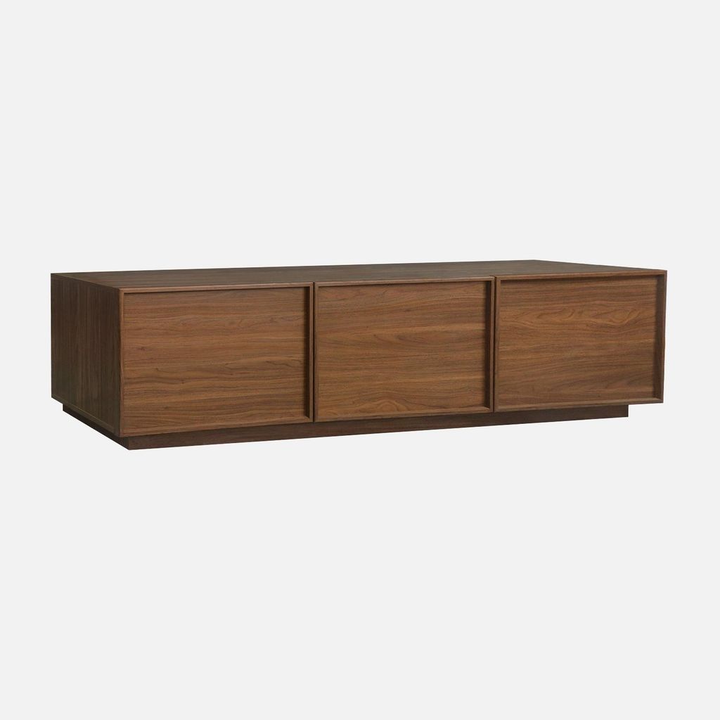A wooden TV stand with three doors against a plain background.