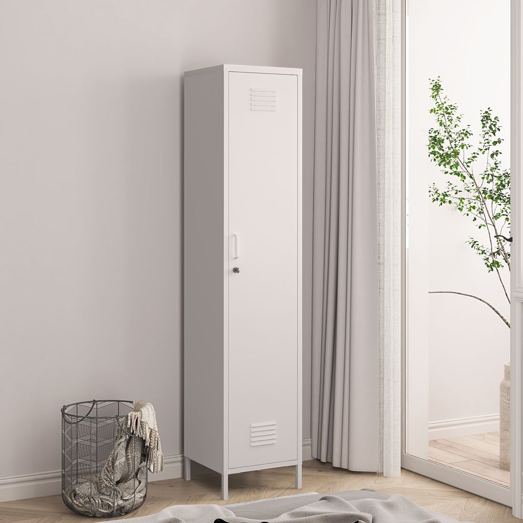 A tall, white metal locker stands next to a window with sheer curtains and a plant. A wire basket with blankets is on the left.
