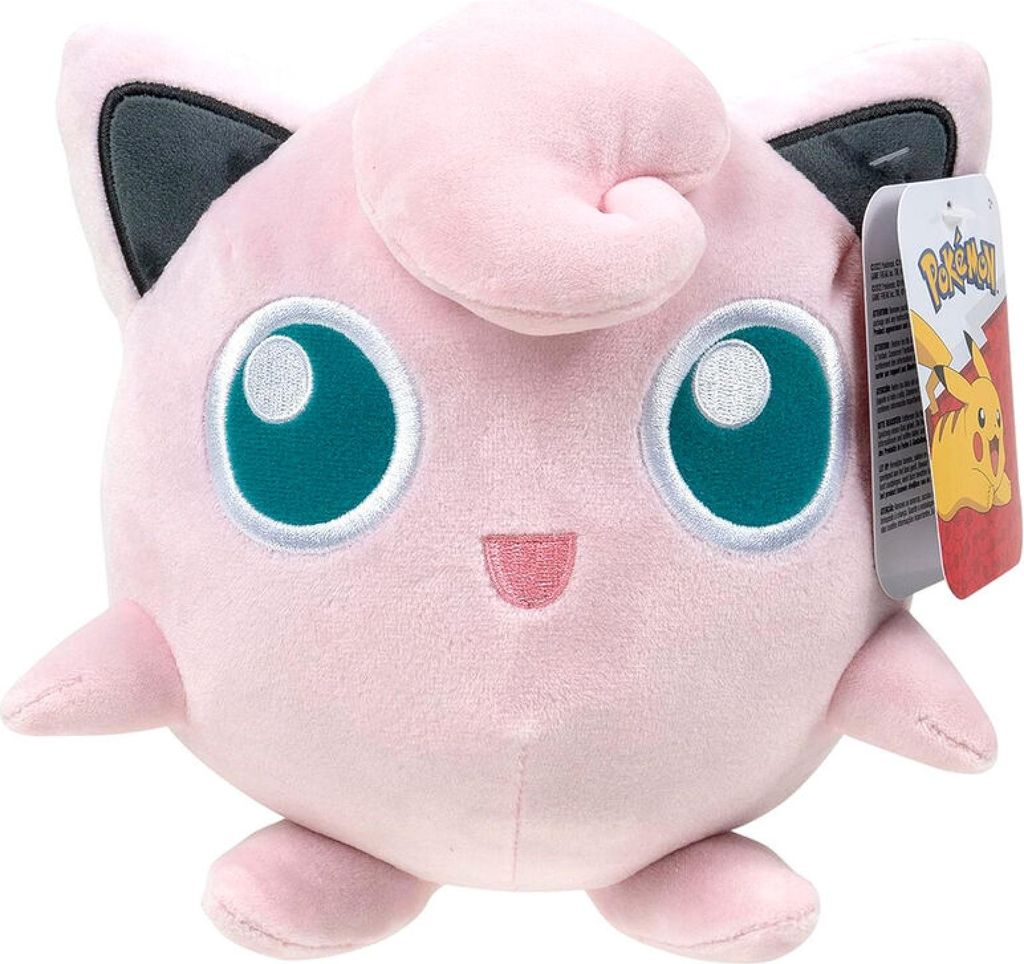 A close-up studio shot of a pink Jigglypuff plush toy with a Pokemon tag attached.