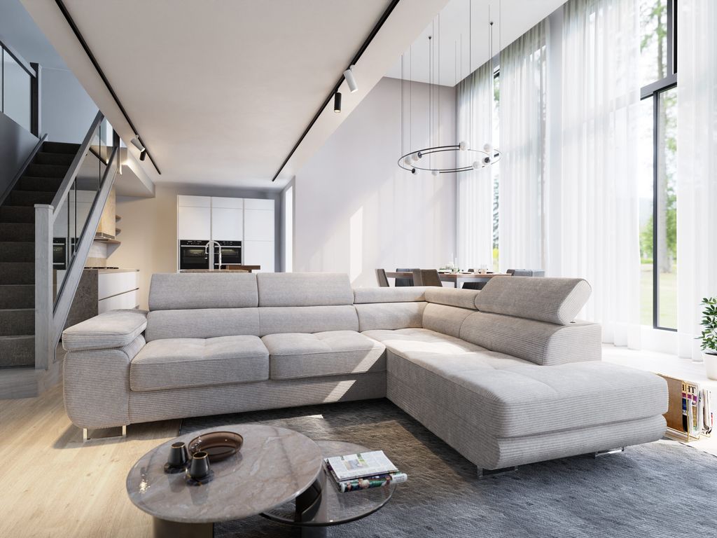 A modern living room with a sectional sofa, coffee table, and stairs.