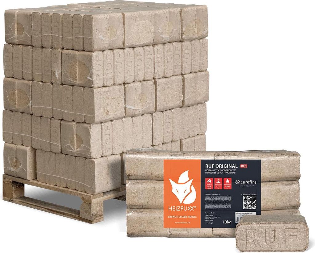 A stack of firewood briquettes on a pallet and a package of briquettes in the foreground.