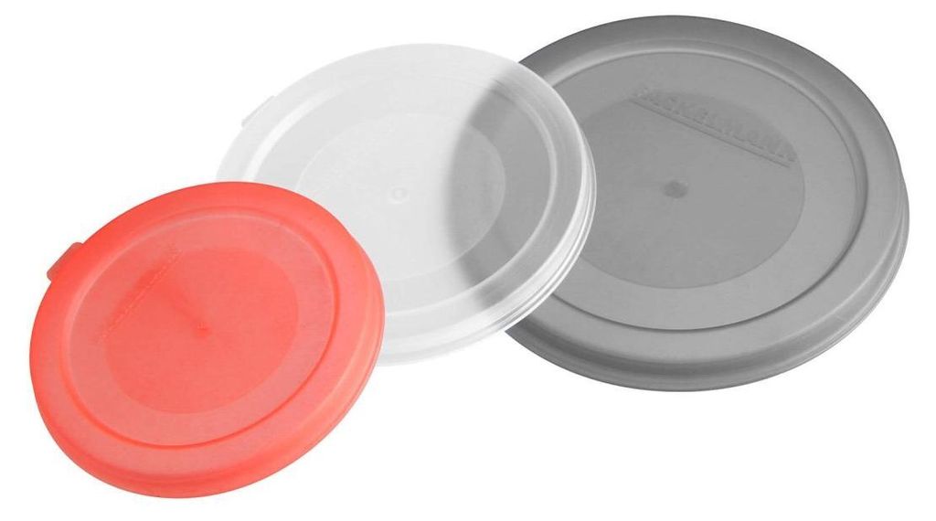 Three round plastic lids of different colors (red, white, and gray) are arranged on a white background.