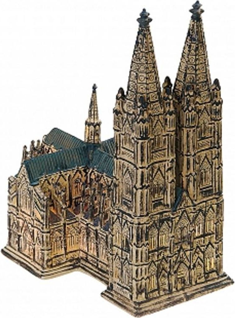 A miniature model of a cathedral with two prominent spires and a smaller central spire, set against a white background.