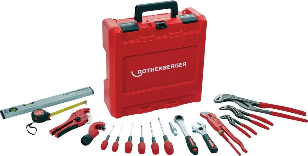 A collection of plumbing tools laid out in front of a red toolbox.