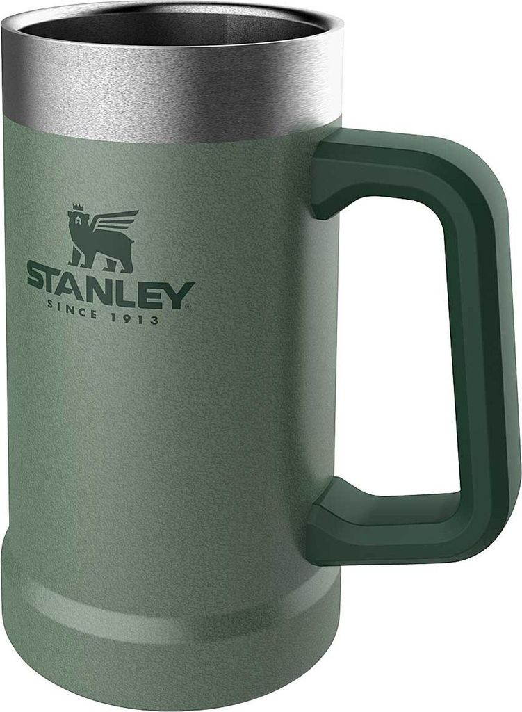 A green Stanley thermal mug with a silver rim and a dark green handle.