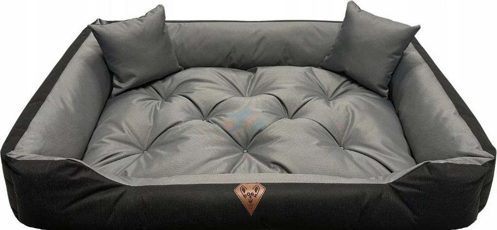 A dog bed with two small pillows on a white background.