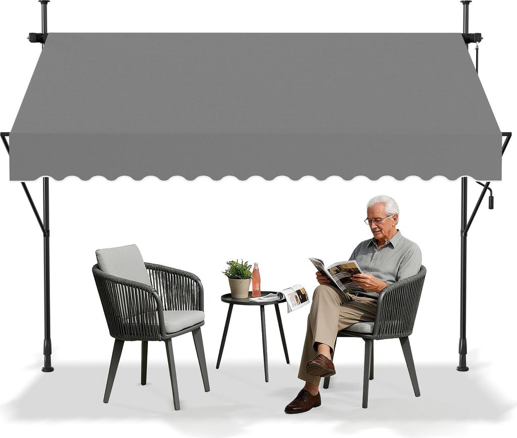 An elderly man sits reading a magazine under a gray awning on a patio, with a chair and small table nearby.