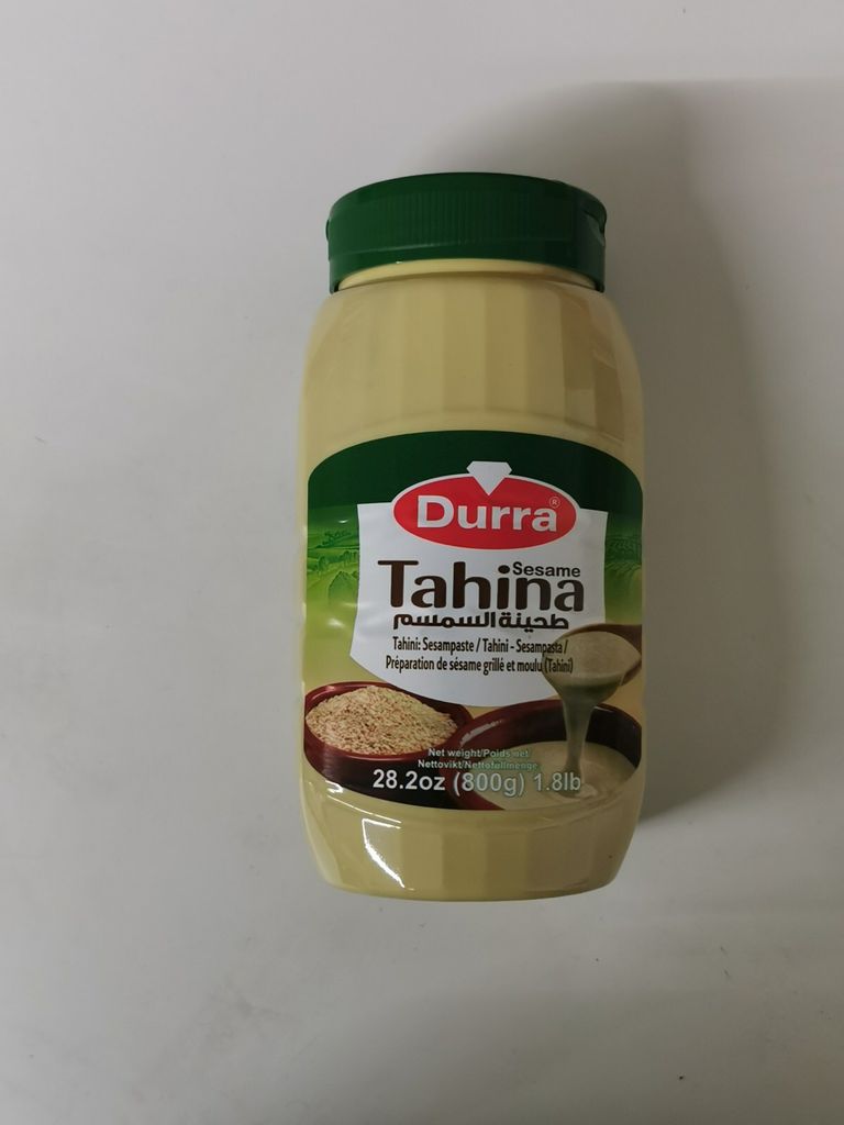 A product shot of a jar of tahini.