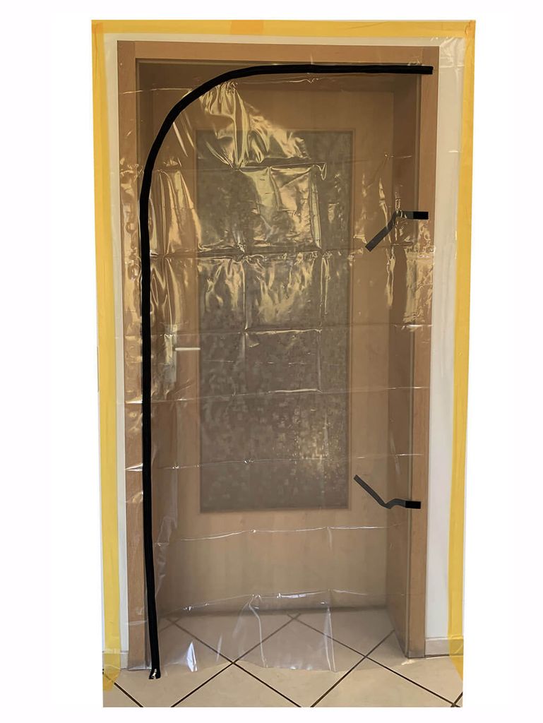 A clear plastic dust protection door with a zipper is installed in a doorway.