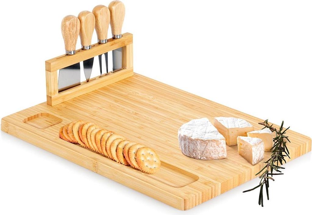 A bamboo cheese board set with cheese knives, crackers, and cheese pieces.