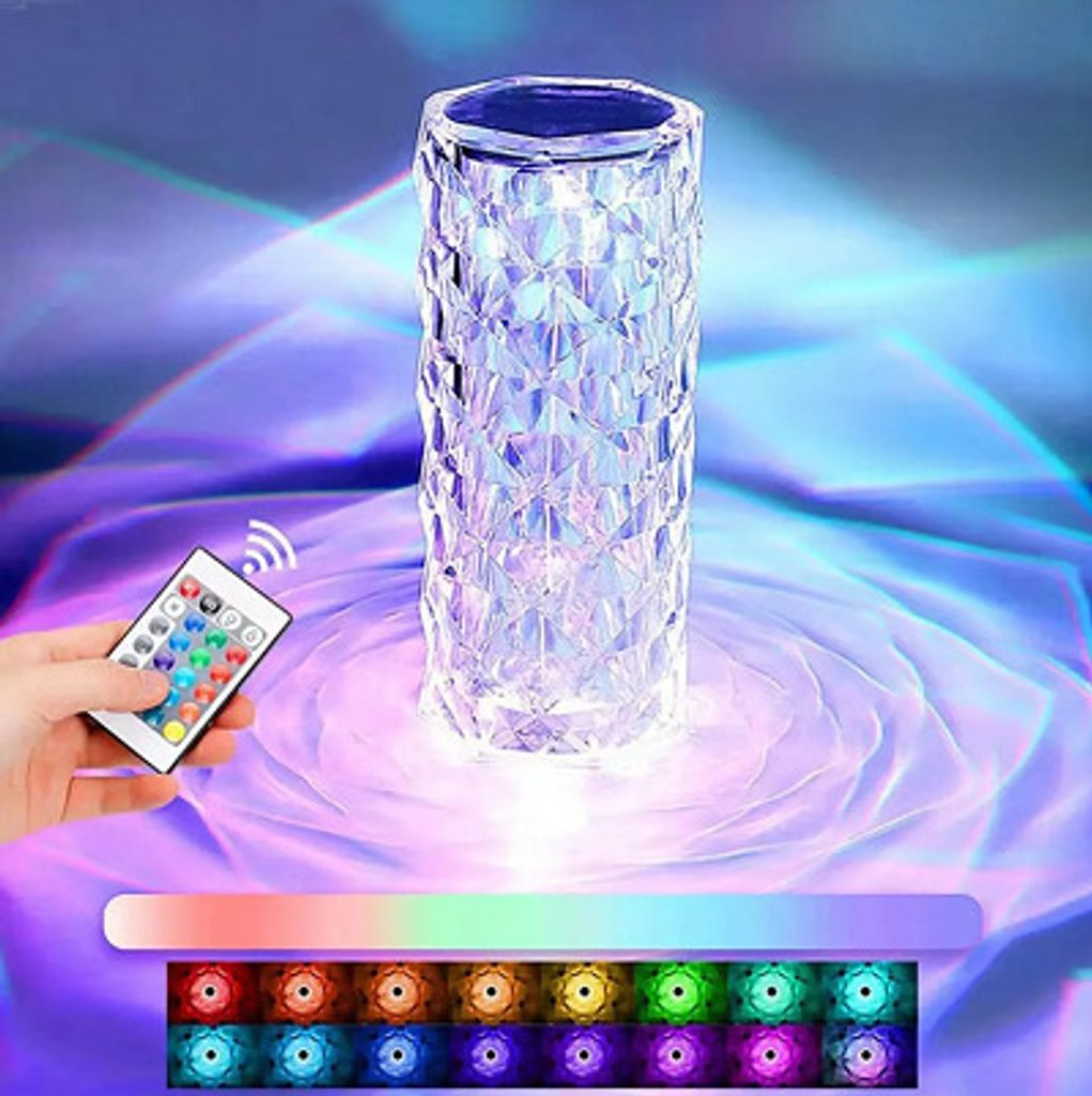 A crystal diamond table lamp with a remote control, displaying various colors.
