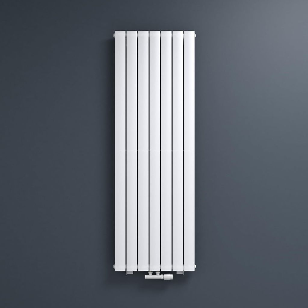 A white vertical radiator is mounted on a dark gray wall.