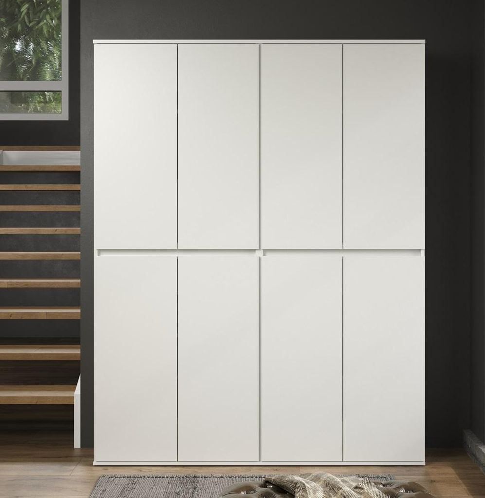 A large, white, eight-door wardrobe is shown in a room with a dark gray wall and wooden stairs.