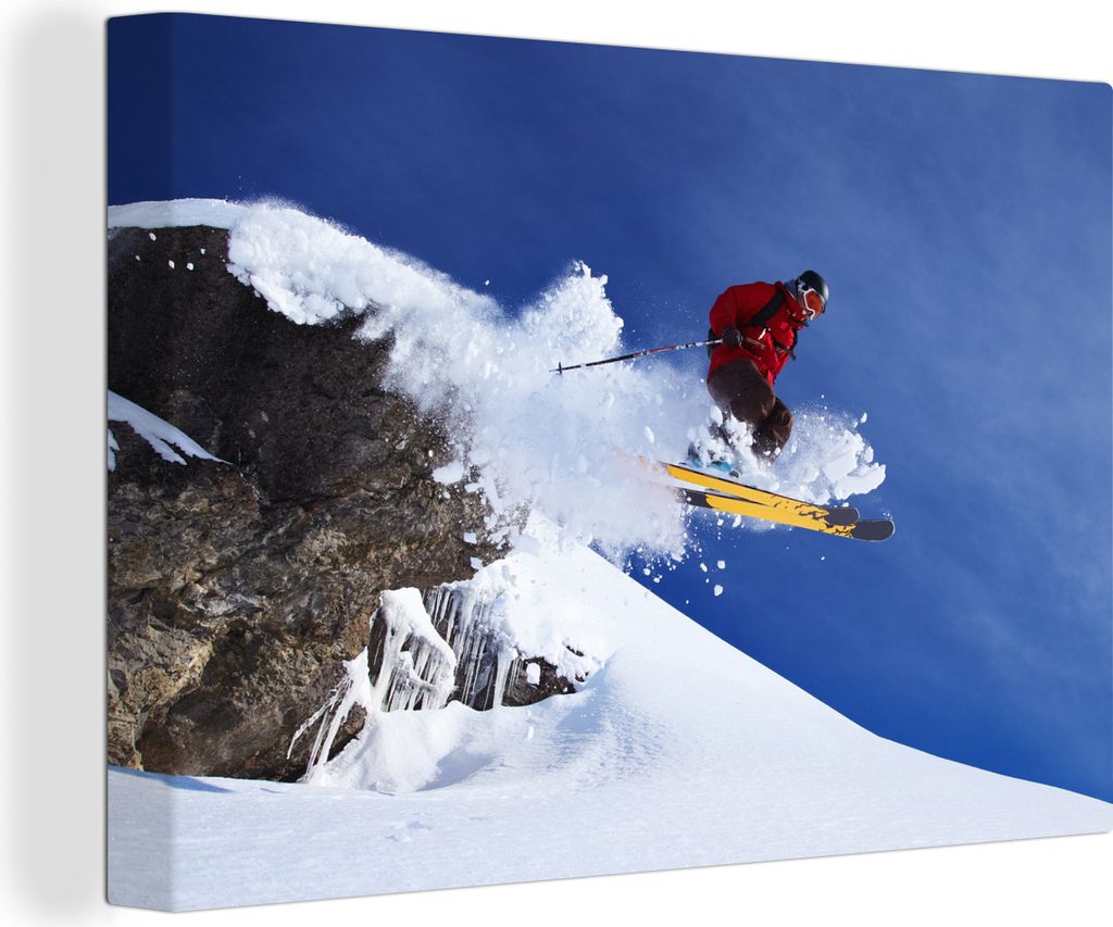 OneMillionCanvasses - Leinwandbilder - 140x90 cm, Ein Skifahrer macht einen Sprung von einem schneebedeckten Felsen, Wandbilder Kunstdruck Wandde...
