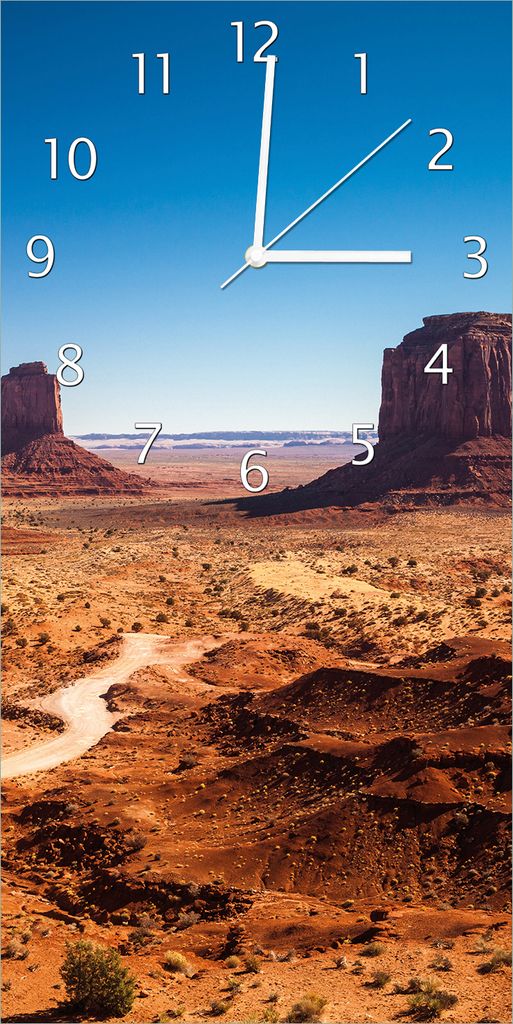 Wallario Design Wanduhr bedruckt, Größe 30 x 60 cm, Motiv: Monument Valley unter blauem Himmel