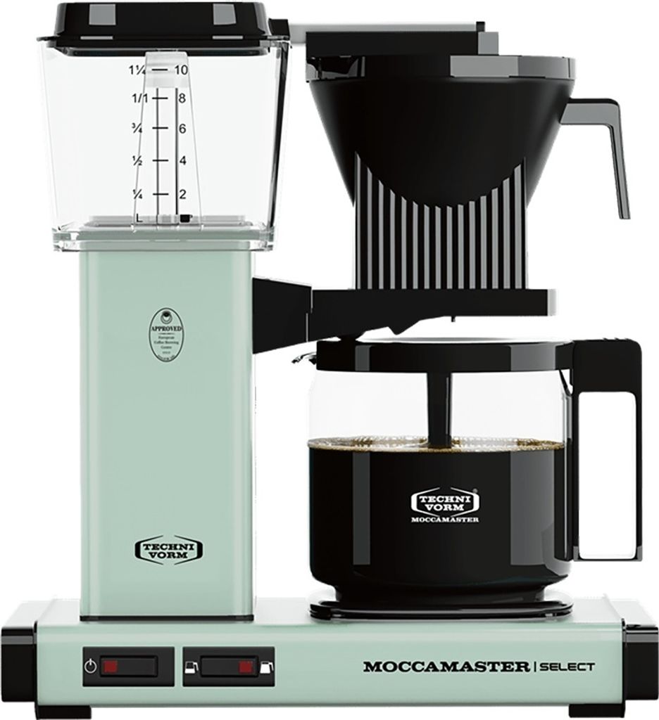A pastel green Moccamaster coffee maker with a glass carafe filled with coffee.