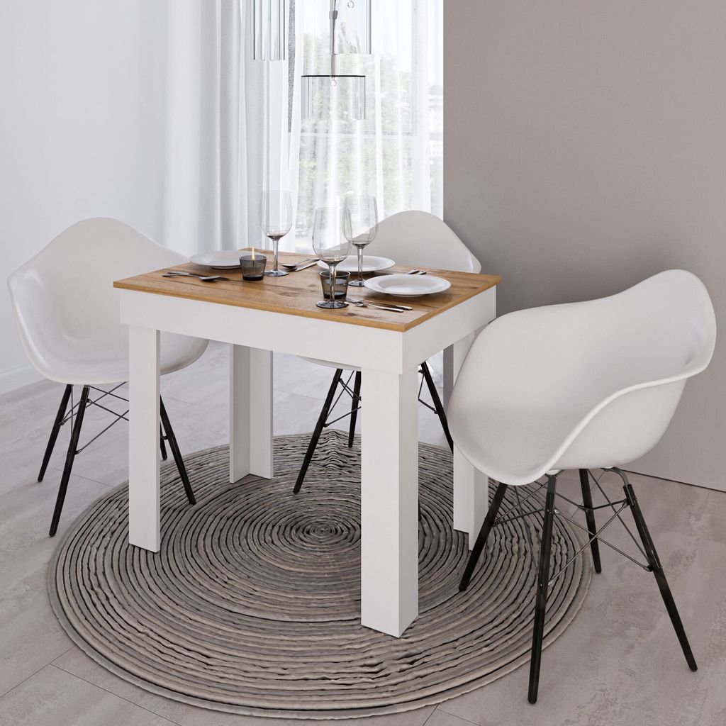 A dining table set with four chairs in a modern dining room.