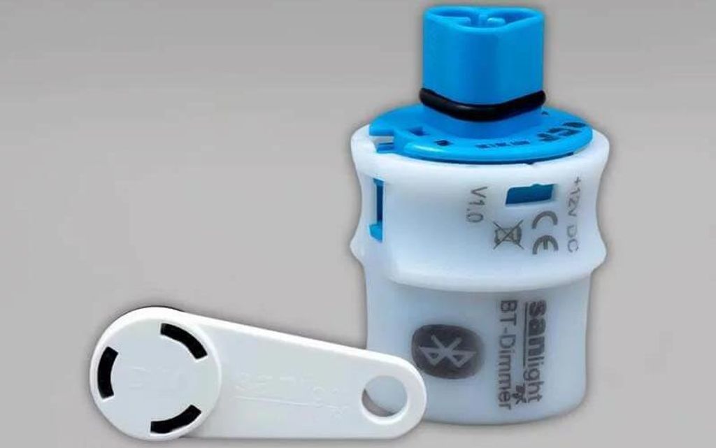A product shot of a Bluetooth dimmer and its accessory.