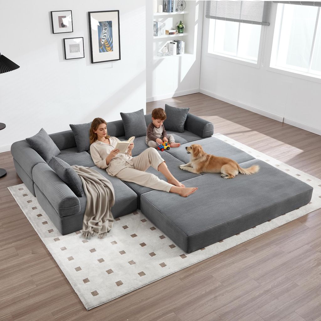 A family and their dog relaxing on a modular sofa in a living room.